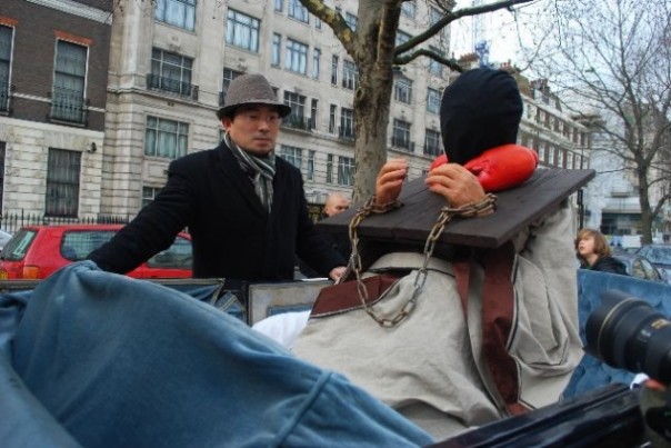 Horse & cart drag man through London